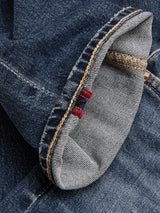 Close-up of the cuff on Blue de Gênes BGvinci Striker Jeans - Dark Distress, highlighting comfort stretch denim made in Italy with visible orange and red stitching details on the seam and hem.