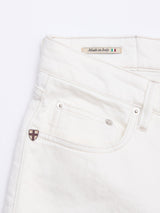 Close-up of BGvinci Bianco Jeans - White by Blue de Gênes in comfort stretch denim, showing the front pocket, shield-shaped metal emblem, belt loop, and a "Made in Italy" label with the Italian flag.
