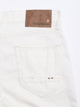 Close-up of BGvinci Bianco Jeans by Blue de Gênes: white, regular fit jeans with a brown leather brand patch, red and white emblem, and an embroidered pocket with Italian flag colors—crafted in comfort stretch Italian denim.