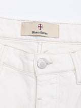 Close-up of the BGvinci Bianco Jeans - White by Blue de Gênes, showing the waistband with a blue label featuring a red and white shield logo above the button and detailed visible stitching. Made in Italy, regular fit.