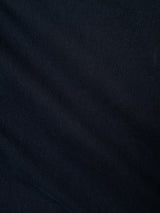 A close-up of the Blue de Gênes BGmenzo Vecchio Chino in Dark Navy highlights its textured fabric, subtle diagonal lines, and gentle folds—details that hint at a comfortable stretch and refined vintage style.