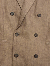 Close-up of the BGcricket Lin Blazer by Blue de Gênes in Grey Mel, featuring a double-breasted design in a linen blend, black buttons, two front pockets, textured fabric, and classic overlapping lapels.