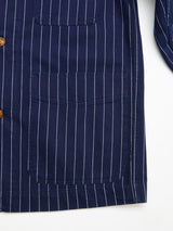 Close-up of the Blue de Gênes BGkendrick Toll Jacket - Navy Stripe, showcasing navy with white pinstripes, relaxed fit, two large front pockets, and brown buttons. The left side is visible against a white background.