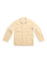 The BGhunter Vecchio Jacket - Pale Khaki by Blue de Gênes is a beige cotton stretch utility jacket with four front flap pockets, collar, and long sleeves—perfect as a versatile field jacket.