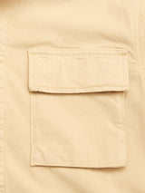 Close-up of the Blue de Gênes BGhunter Vecchio Jacket in pale khaki, a beige cotton-stretch field jacket with a rectangular flap pocket and visible edge stitching.