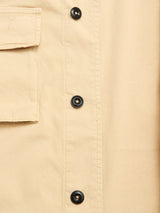 Close-up of the Blue de Gênes BGhunter Vecchio Jacket in Pale Khaki, highlighting its cotton stretch fabric, four black buttons in a vertical row, and a stitched flap pocket for classic field jacket style.