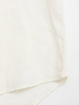 Close-up of the BGenric Hope L/S Shirt in Chalk by Blue de Gênes, showing fine stitching on soft, lightweight linen—ideal for summer. The shirt’s white fabric is displayed against a matching background.