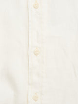 Close-up of the BGenric Hope L/S Shirt in Chalk by Blue de Gênes, a cream-colored, breathable summer shirt with a light fabric, vertical button row, visible placket stitching, and a smart cut away collar.