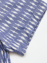Close-up of the BGforma Onda S/S Shirt by Blue de Gênes in a blue pattern with white geometric ikat and tribal-inspired details, showing the hem and edge seams against a plain white background.