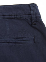Close-up of the BGmenzino Vecchio Shorts - Dark Navy by Blue de Gênes, highlighting the back pocket with a stitched shield emblem above it and a visible belt loop at the waistband.