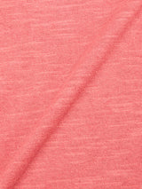 Close-up of BGmonty Knit - Coral by Blue de Gênes, featuring soft heathered cotton linen blend fabric in pink with a textured knit pattern, diagonal fold, and subtle color variations.