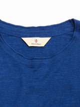 Close-up of the neckline of the BGmonty Knit - Navy Peony by Blue de Gênes, showing a cream label inside with the brand name and a small red and blue shield logo.