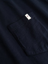 Close-up of the BGoscar T-Shirt - Dark Navy by Blue de Gênes, featuring a soft 100% cotton crewneck and a pocket with a small white tag and red diamond logo at the edge.