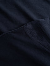Close-up of the Blue de Gênes BGoscar T-Shirt - Dark Navy shows 100% cotton fabric with overlapping layers and visible texture, revealing subtle weave and shading differences.