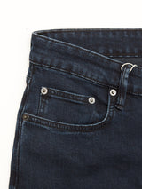 Close-up of the BGvinci Black OD Jeans by Blue de Gênes in blue black denim, highlighting the waistband, belt loop, front pocket, and coin pocket with metal rivets; crafted from comfort stretch denim against a white background.