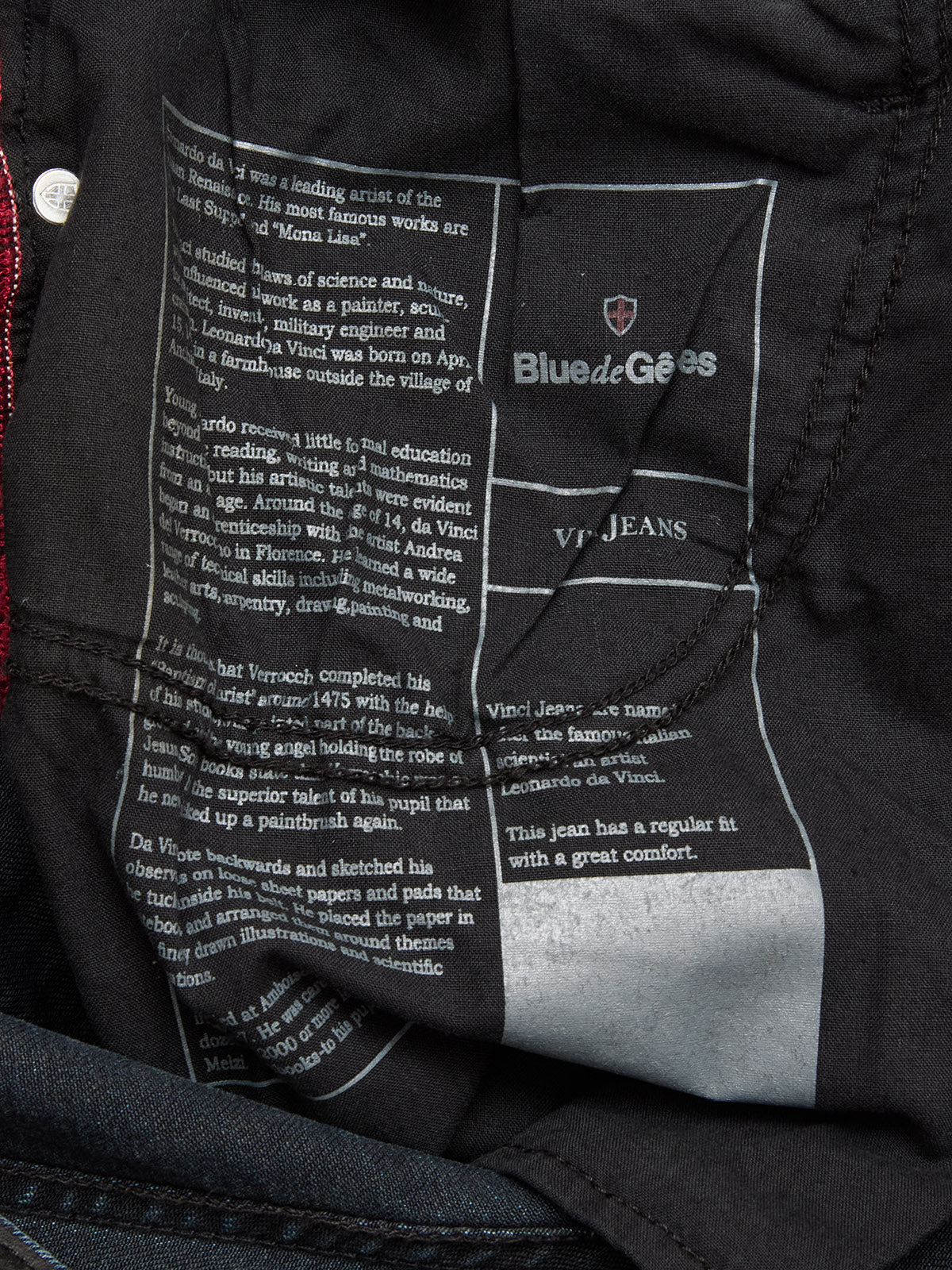 Clothing label inside a pair of BGvinci Black OD Jeans by Blue de Gênes, made from blue-black comfort stretch denim, featuring white printed Leonardo da Vinci text, care instructions, and brand info.