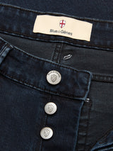 Close-up of BGvinci Black OD Jeans in blue-black denim by Blue de Gênes, featuring comfort stretch, branded metal buttons, and a waistband label with the Blue de Gênes shield logo.