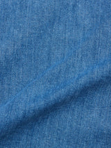 Close-up of BGpontus Denim Overshirt - Used by Blue de Gênes, featuring blue cotton blend denim with a textured weave and diagonal fold—perfect for a relaxed fit overshirt.