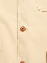 Close-up of the Blue de Gênes BGnorly Rodas Blazer in Pale Khaki, showcasing its beige cotton hemp blend, brown buttons, and a flap pocket at the top right. Detailed stitching and buttonholes are clearly visible.
