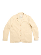 The BGnorly Rodas Blazer in pale khaki by Blue de Gênes is a relaxed-fit cotton-hemp blend with three brown buttons, front patch pockets, a notched collar, and sleeve button details, shown on a white background.