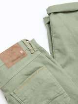 BGpaulo Pavia Pant in Shadow Green by Blue de Gênes—cotton stretch chinos inspired by vintage military style, featuring a brown leather brand label above the back pocket. Shown folded on a white background.
