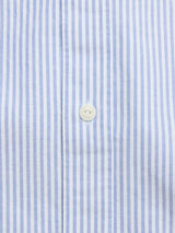 Close-up of the BGsander Oxford Shirt - Blue Stripe by Blue de Gênes, showcasing blue and white vertical stripes and a central white button.