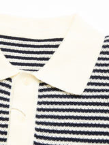 Close-up of the BGbob Knit Polo - Navy by Blue de Gênes, featuring a cream-colored collar and button placket with a horizontal black and white striped knit pattern.