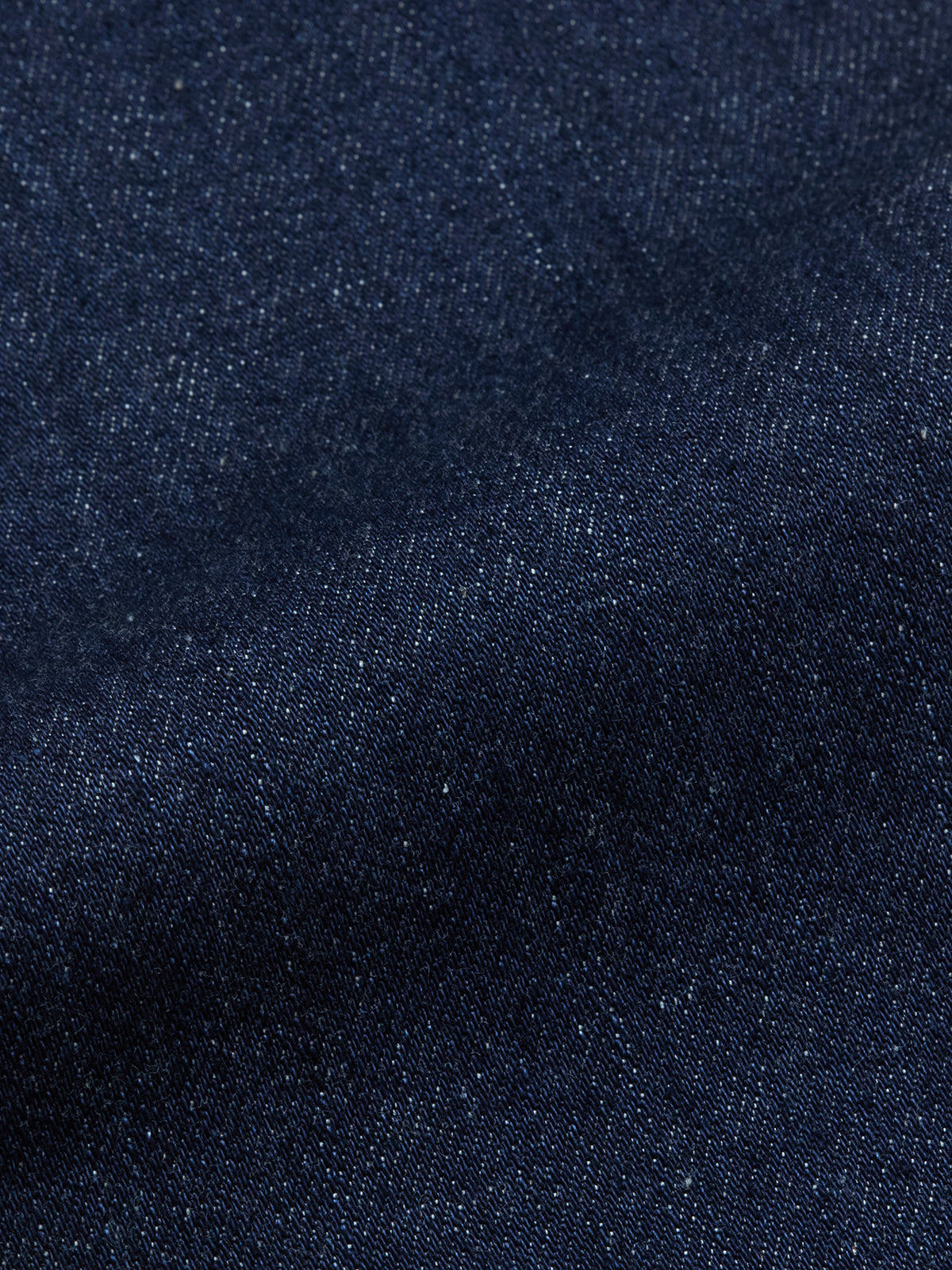 Close-up of Blue de Gênes Vinci Pala Dark V2 Jeans in dark blue denim, highlighting the comfort stretch fabrics textured weave pattern and subtle color variations.