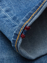 Close-up of the cuff on Blue de Gênes Vinci Pala Used V2 Jeans in Denim Blue, made from comfort stretch denim, featuring detailed orange stitching and a small red accent thread along the seam.