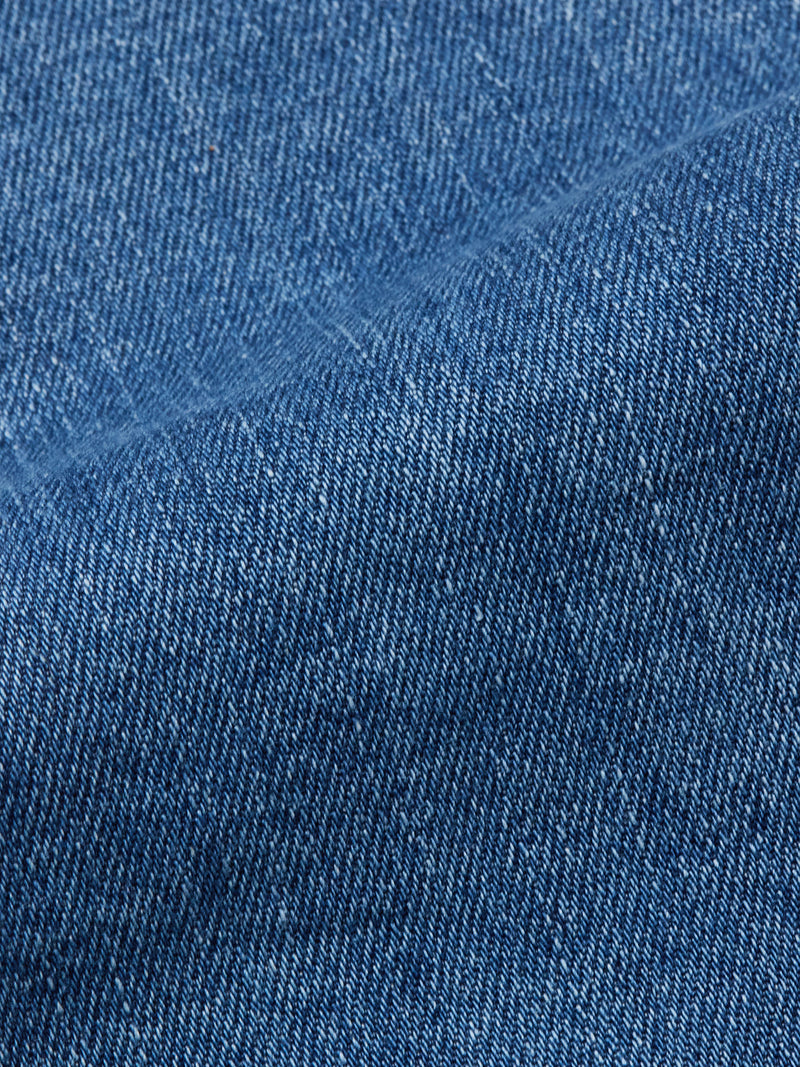 Close-up of Vinci Pala Used V2 Jeans by Blue de Gênes in denim blue, highlighting the comfort stretch fabric’s diagonal weave and texture with a midline fold—ideal for regular fit jeans made in Italy.