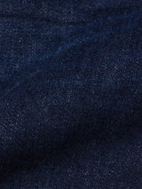Close-up of durable dark blue denim fabric from Blue de Gênes Repi Dai V Dark V2 Jeans, highlighting the slim-fit texture, visible weave, gentle fold, and subtle color variations.