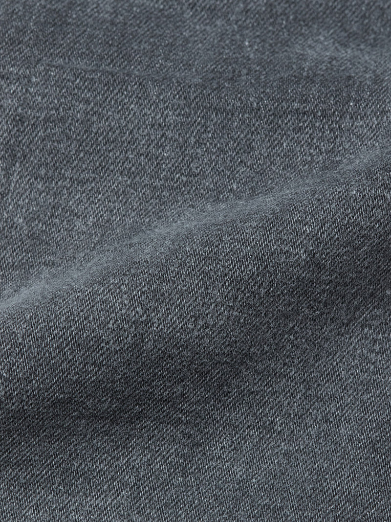 Close-up of Blue de Gênes Repi Giulio Light V2 Jeans in grey denim, highlighting the comfort stretch fabrics woven texture, subtle diagonal pattern, and a visible seam or fold.