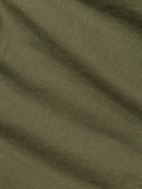 A close-up of the BGpaulo Pavia 1 V2 Chino - Army by Blue de Gênes shows olive green stretch cotton fabric with a soft, slightly textured surface and gentle diagonal folds, echoing vintage military style.