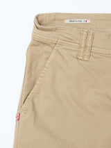 Close-up of Blue de Gênes Paulo Pavia 1 V2 Chino in khaki shows a front pocket, belt loop, visible stitching, Made in Italy label with Italian flag inside the waistband, and a small red and white shield logo near the pocket.