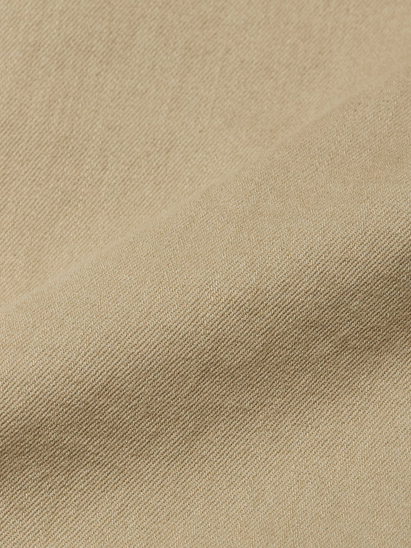 Close-up of the Paulo Pavia 1 V2 Chino in Khaki by Blue de Gênes, showcasing beige fabric with a subtle diagonal weave and soft fold that highlights the smooth texture—ideal for classic chino pants.