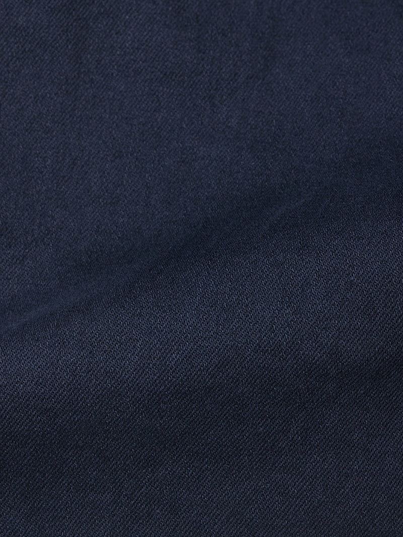 Close-up of Blue de Gênes Paulo Pavia 1 V2 Chino in Midnight Blue, showing dark blue cotton stretch fabric with a subtle diagonal weave and soft shadows—evoking the classic look of vintage military pants.