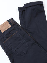 The Blue de Gênes Paulo Pavia 1 V2 Chino in Midnight Blue features a tan leather waistband patch, stitched details, visible back pocket, and is made from comfortable cotton stretch fabric.