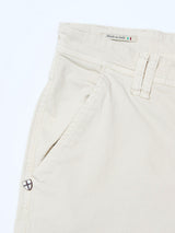 Close-up of BGpaulo Pavia 1 V2 Chino - Ecru by Blue de Gênes, showing the cotton stretch waistband with “Made in Italy” text and flag, belt loop, side pocket, and a small shield-shaped logo.