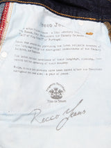 Close-up of the inside pocket lining of Recco F V2 Jeans - Rinse Wash by Blue de Gênes, showing printed historical text, visible stitching, and part of a belt loop at the top.