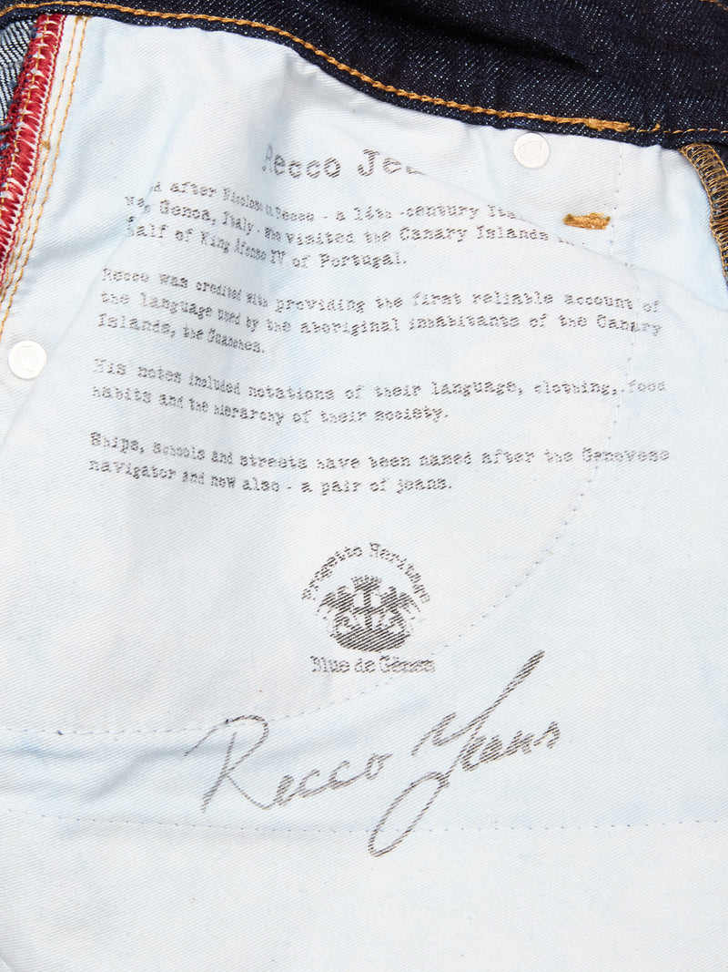Close-up of the inside pocket lining of Recco F V2 Jeans - Rinse Wash by Blue de Gênes, showing printed historical text, visible stitching, and part of a belt loop at the top.