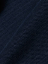 Close-up of BGpaulo Teo Pant in Dark Navy by Blue de Gênes, showing durable textured fabric with subtle diagonal creases and fine grid-like patterns inspired by vintage military styles.