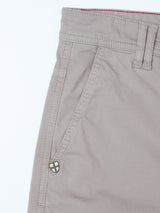 Close-up of the upper part of the Blue de Gênes BGpaulo Teo Pant in flint gray, featuring a side pocket, belt loop, and a small shield-shaped decorative emblem near the pocket.