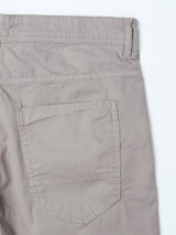 Close-up of the back pocket and waistband of flint gray BGpaulo Teo Pant by Blue de Gênes, highlighting stitching details and a right-side belt loop.