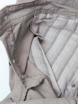 Close-up of the BGpaulo Teo Pant - Flint gray by Blue de Gênes, highlighting its light gray fabric with vertical black and white striped lining, classic vintage military-inspired details, silver snap buttons, and red stitching along the edge.