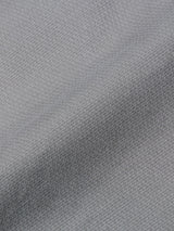 A close-up of the BGpaulo Teo Pant in Flint gray by Blue de Gênes, showing its soft, flexible fabric with a small repeating texture—evoking the comfort of classic cotton chinos or vintage military pants.