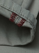 Close-up of the BGpaulo Teo Pant in Shadow Green by Blue de Gênes, showing textured fabric and folded hem with double red stitching—details inspired by vintage military craftsmanship for durable, character-rich chinos.