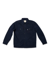 The Blue de Gênes BGpontus Teo Overshirt in Dark Navy features long sleeves, a collar, and two button-flap chest pockets, crafted from honeycomb cotton fabric and shown laid flat on a white background.
