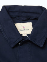 Close-up of the BGpontus Teo Overshirt in dark navy textured cotton, featuring a Blue de Gênes label and small red and white shield logo inside the collar.