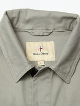 Close-up of the BGpontus Teo Overshirt in Shadow Green by Blue de Gênes, featuring a relaxed fit, buttoned top, and signature label with a small shield emblem on the inside neck.
