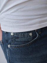Close-up of a person wearing BGmarco Rowan Jeans - Used by Blue de Gênes, highlighting the front pocket and waistband of these classic 5-pocket relaxed fit denim jeans.
